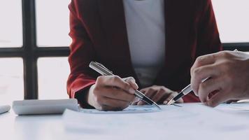 Financial analysts analyze business financial reports on a digital tablet planning investment project during a discussion at a meeting of corporate showing the results of their successful teamwork. video