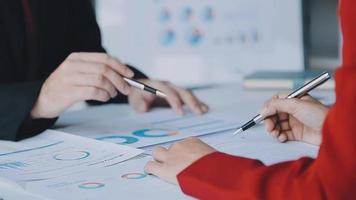 Financial analysts analyze business financial reports on a digital tablet planning investment project during a discussion at a meeting of corporate showing the results of their successful teamwork. video