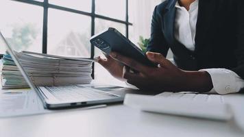 Financial analysts analyze business financial reports on a digital tablet planning investment project during a discussion at a meeting of corporate showing the results of their successful teamwork. video