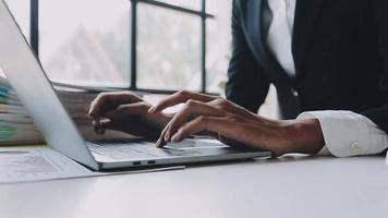 Financial analysts analyze business financial reports on a digital tablet planning investment project during a discussion at a meeting of corporate showing the results of their successful teamwork. video