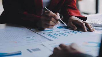 Financial analysts analyze business financial reports on a digital tablet planning investment project during a discussion at a meeting of corporate showing the results of their successful teamwork. video