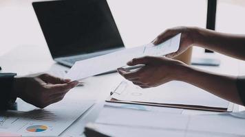 Financial analysts analyze business financial reports on a digital tablet planning investment project during a discussion at a meeting of corporate showing the results of their successful teamwork. video