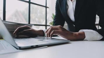 Financial analysts analyze business financial reports on a digital tablet planning investment project during a discussion at a meeting of corporate showing the results of their successful teamwork. video