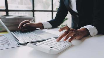 Financial analysts analyze business financial reports on a digital tablet planning investment project during a discussion at a meeting of corporate showing the results of their successful teamwork. video