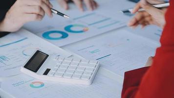 Financial analysts analyze business financial reports on a digital tablet planning investment project during a discussion at a meeting of corporate showing the results of their successful teamwork. video