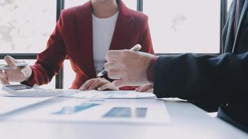 Financial analysts analyze business financial reports on a digital tablet planning investment project during a discussion at a meeting of corporate showing the results of their successful teamwork. video