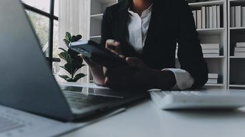 Financial analysts analyze business financial reports on a digital tablet planning investment project during a discussion at a meeting of corporate showing the results of their successful teamwork. video