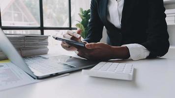 Financial analysts analyze business financial reports on a digital tablet planning investment project during a discussion at a meeting of corporate showing the results of their successful teamwork. video