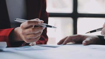 Financial analysts analyze business financial reports on a digital tablet planning investment project during a discussion at a meeting of corporate showing the results of their successful teamwork. video