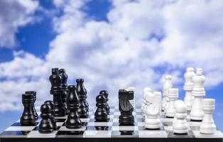 A game of chess with passing clouds behind photo