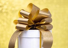 A gift box with a golden bow photo