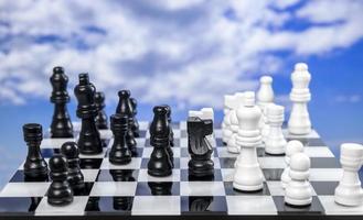 A game of chess with passing clouds behind photo