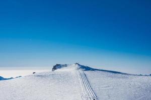 Ski slope and snow covered winter mountains. Matterhorn is a mountain in the Pennine Alps on the border between Switzerland and Italy. Peak of the Matterhorn Glacier Paradise. photo