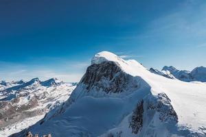 Ski slope and snow covered winter mountains. Matterhorn is a mountain in the Pennine Alps on the border between Switzerland and Italy. Peak of the Matterhorn Glacier Paradise. photo