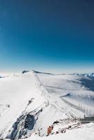 Ski slope and snow covered winter mountains. Matterhorn is a mountain in the Pennine Alps on the border between Switzerland and Italy. Peak of the Matterhorn Glacier Paradise. photo