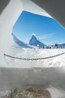 The Iglu Dorf window - a restaurant and bar in an igloo on the Gornergrat slopes. Zermatt, Switzerland. Famous Matterhorn peak visible through the window. photo