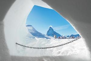 The Iglu Dorf window - a restaurant and bar in an igloo on the Gornergrat slopes. Zermatt, Switzerland. Famous Matterhorn peak visible through the window. photo