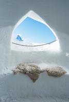 The Iglu Dorf window - a restaurant and bar in an igloo on the Gornergrat slopes. Zermatt, Switzerland. Famous Matterhorn peak visible through the window. photo