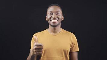 Stylish and attractive african young man looking at camera and giving check mark. Satisfied African young man giving approval sign and nodding positively. video