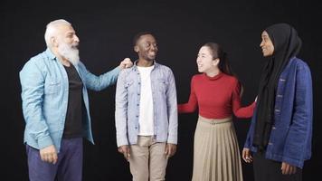 Group of friends from different races chatting and having fun. They are friendly and happy. Asian woman, European man and African man and woman chatting. A happy and friendly image. video