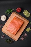 Fresh tasty raw red fish fillet with spices and herbs photo
