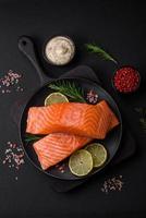 Fresh tasty raw red fish fillet with spices and herbs photo
