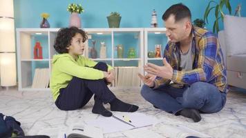 Happy family parent father teaching math to their son. Child learning numbers and digits. Parent father helping boy who has difficulty in learning homeschooling, teaching counting numbers. video