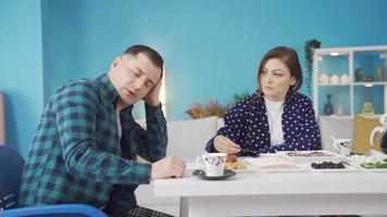 The thoughtful man who is bored at breakfast is shown love by his wife as morale and support. Unity in Marriage. video