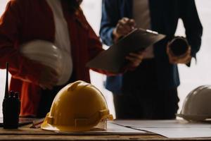 Construction and structure concept of engineer working drawing on blueprint meeting for project working with partner on model building and engineering tools in working site, construction concept photo