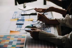 Close up ux developer and ui designer use augmented reality brainstorming about mobile app interface wireframe design on desk at modern office.Creative digital development agency photo