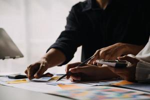 Close up ux developer and ui designer use augmented reality brainstorming about mobile app interface wireframe design on desk at modern office.Creative digital development agency photo