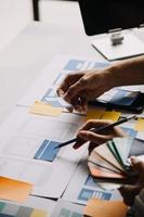 Close up ux developer and ui designer use augmented reality brainstorming about mobile app interface wireframe design on desk at modern office.Creative digital development agency photo