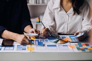 Close up ux developer and ui designer use augmented reality brainstorming about mobile app interface wireframe design on desk at modern office.Creative digital development agency photo