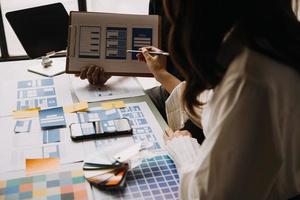 Close up ux developer and ui designer use augmented reality brainstorming about mobile app interface wireframe design on desk at modern office.Creative digital development agency photo