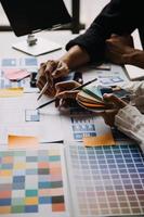 Close up ux developer and ui designer use augmented reality brainstorming about mobile app interface wireframe design on desk at modern office.Creative digital development agency photo