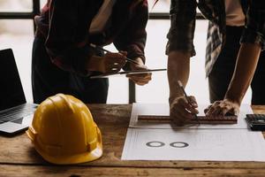 Construction and structure concept of engineer working drawing on blueprint meeting for project working with partner on model building and engineering tools in working site, construction concept photo