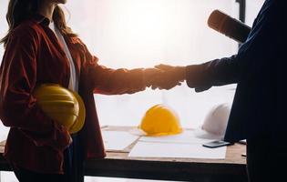 Construction and structure concept of engineer working drawing on blueprint meeting for project working with partner on model building and engineering tools in working site, construction concept photo