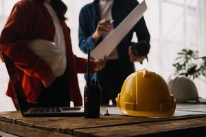 Construction and structure concept of engineer working drawing on blueprint meeting for project working with partner on model building and engineering tools in working site, construction concept photo