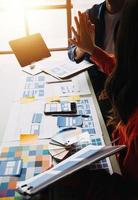 Close up ux developer and ui designer use augmented reality brainstorming about mobile app interface wireframe design on desk at modern office.Creative digital development agency photo