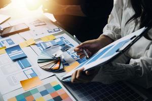 Close up ux developer and ui designer use augmented reality brainstorming about mobile app interface wireframe design on desk at modern office.Creative digital development agency photo