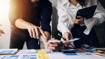 Close up ux developer and ui designer use augmented reality brainstorming about mobile app interface wireframe design on desk at modern office.Creative digital development agency photo