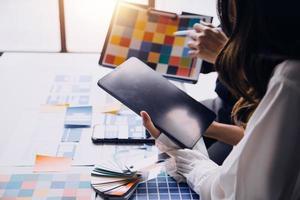 Close up ux developer and ui designer use augmented reality brainstorming about mobile app interface wireframe design on desk at modern office.Creative digital development agency photo