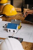 Construction and structure concept of engineer working drawing on blueprint meeting for project working with partner on model building and engineering tools in working site, construction concept photo
