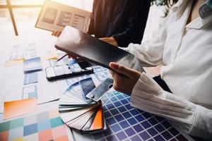 Close up ux developer and ui designer use augmented reality brainstorming about mobile app interface wireframe design on desk at modern office.Creative digital development agency photo