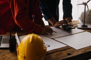 Construction and structure concept of engineer working drawing on blueprint meeting for project working with partner on model building and engineering tools in working site, construction concept photo