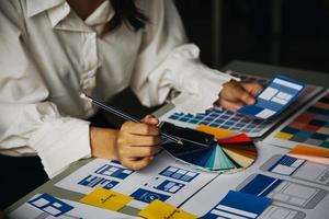 Close up ux developer and ui designer use augmented reality brainstorming about mobile app interface wireframe design on desk at modern office.Creative digital development agency photo