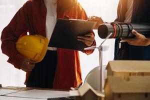 Construction and structure concept of engineer working drawing on blueprint meeting for project working with partner on model building and engineering tools in working site, construction concept photo