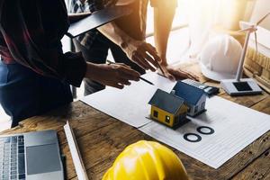 Construction and structure concept of engineer working drawing on blueprint meeting for project working with partner on model building and engineering tools in working site, construction concept photo