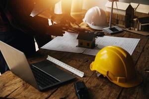Construction and structure concept of engineer working drawing on blueprint meeting for project working with partner on model building and engineering tools in working site, construction concept photo