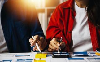 Close up ux developer and ui designer use augmented reality brainstorming about mobile app interface wireframe design on desk at modern office.Creative digital development agency photo